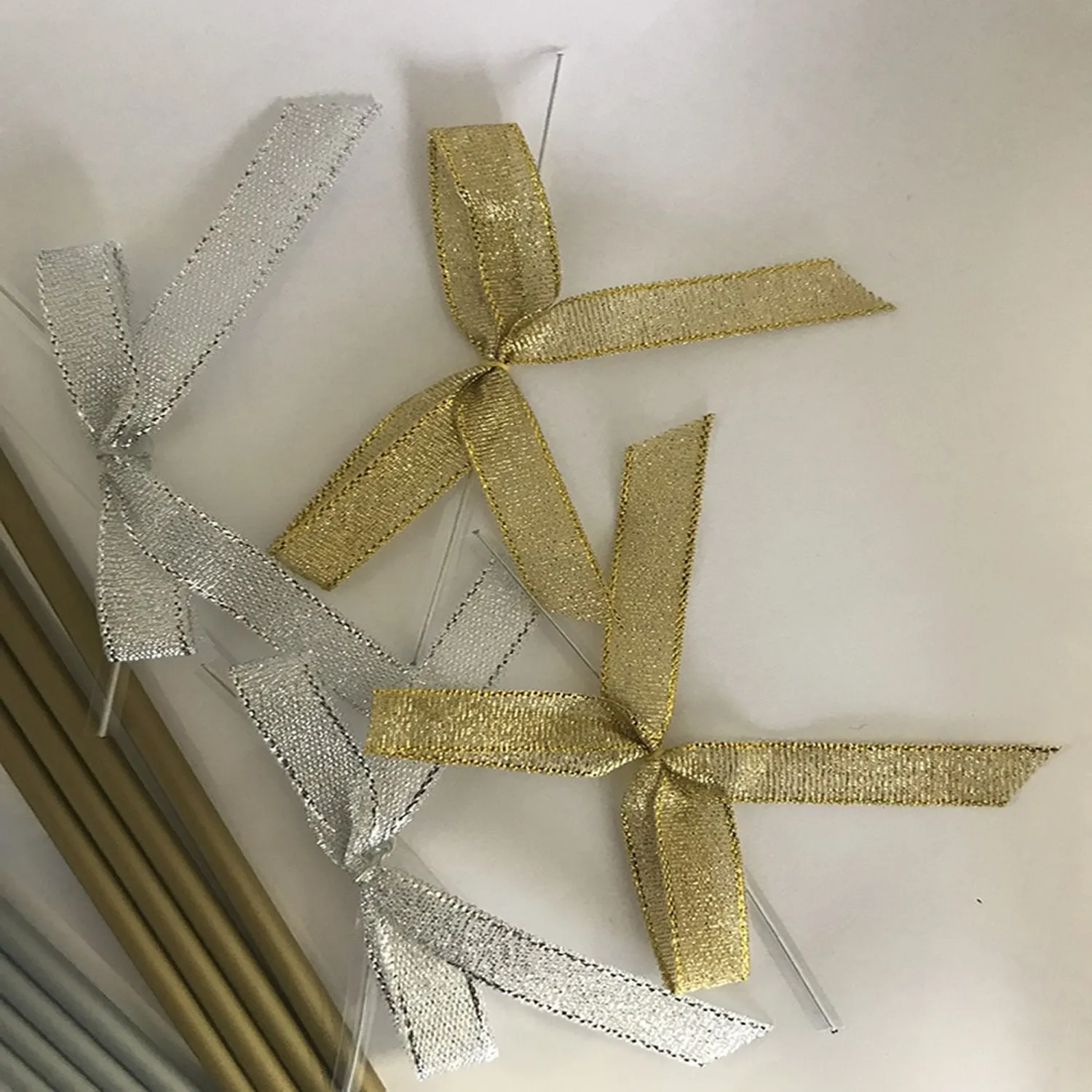 Gold and Silver Cake Pop Sticks, with silver and gold Ribbon Bows", along with 3" x 5" Clear Plastic bags - Qty 50/pack